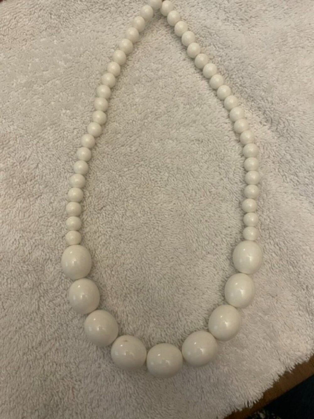Graduated white plastic beaded statement necklace